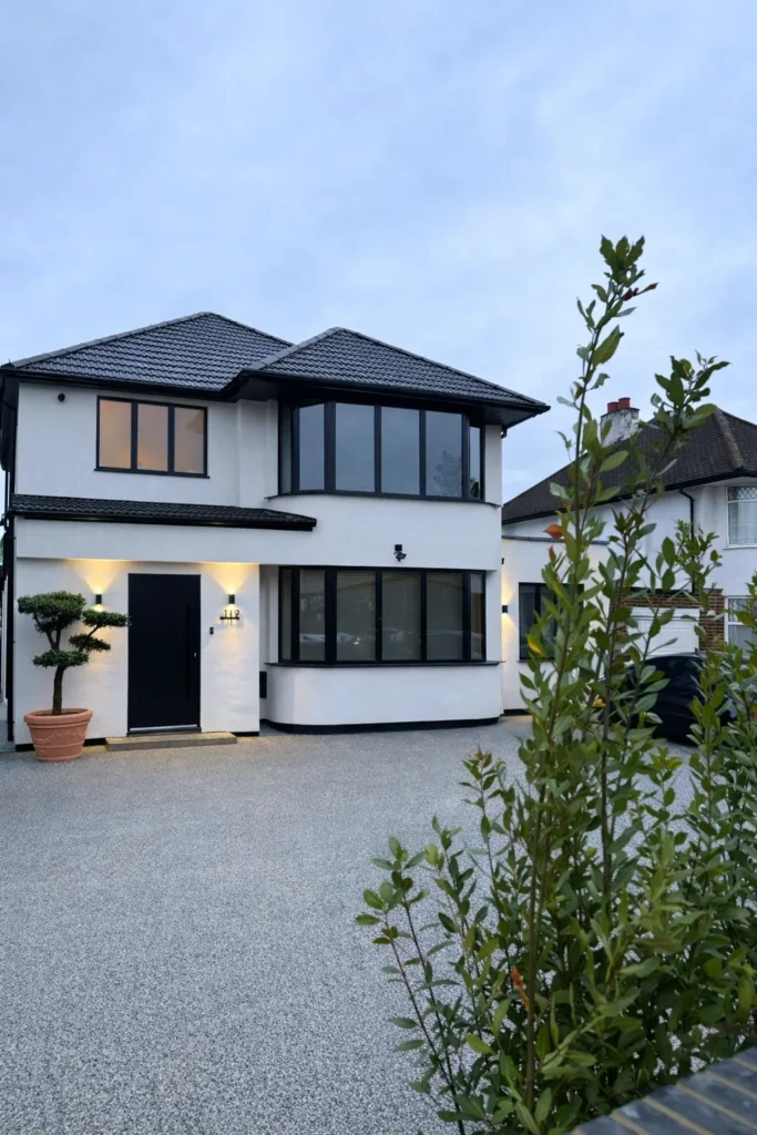 Front of the remodelled house in Sudbury seen across the resin driveway, with the converted garage beside it