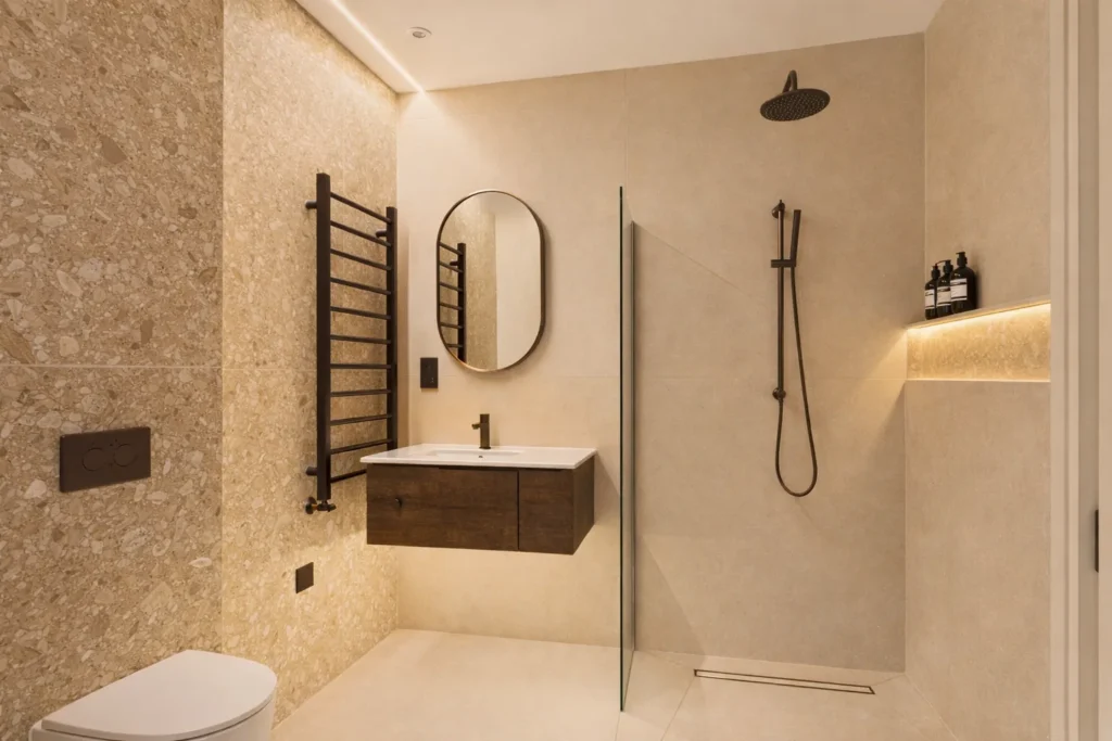 Shower room with terrazzo-effect and stone-effect tiles, a walk-in shower, a dark timber vanity and bronze fittings